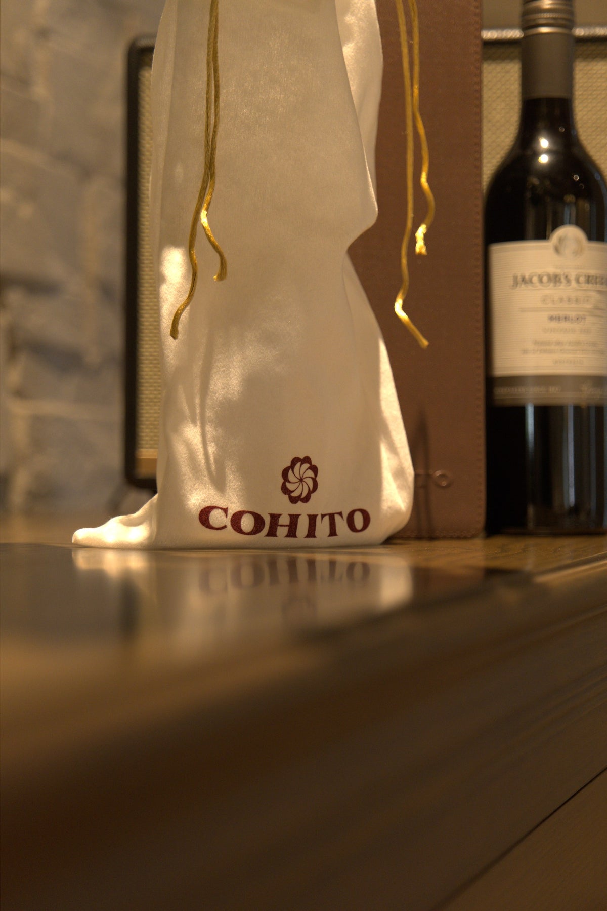 Cohito dust bag beside the brown EVA bottle holder